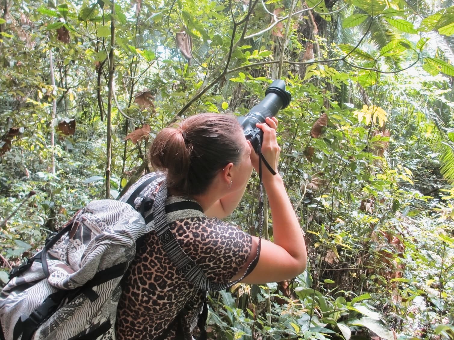 Renee photographing in the forest